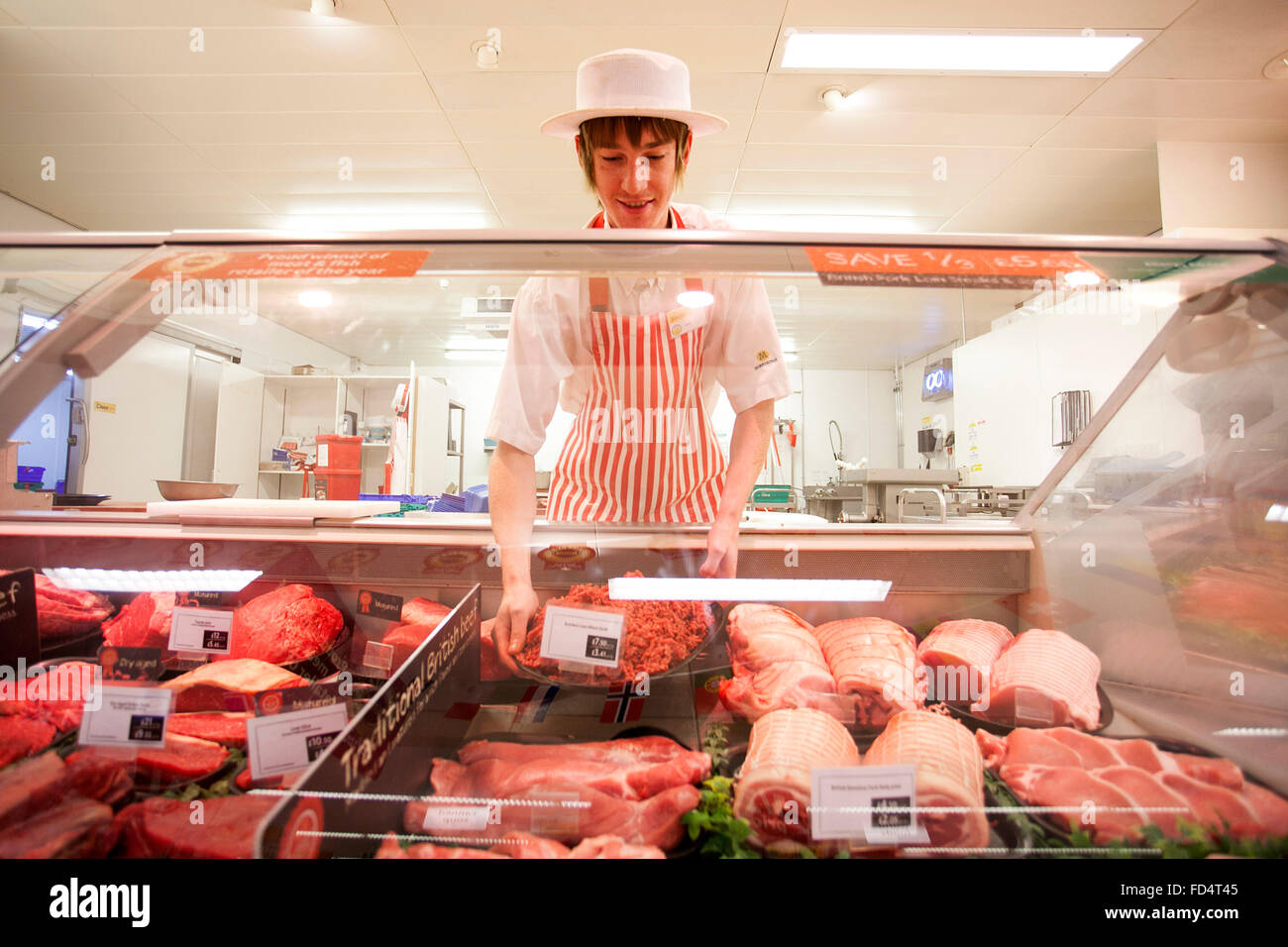 Morrisons supermarket. A man works on the butcher counter Stock Photo