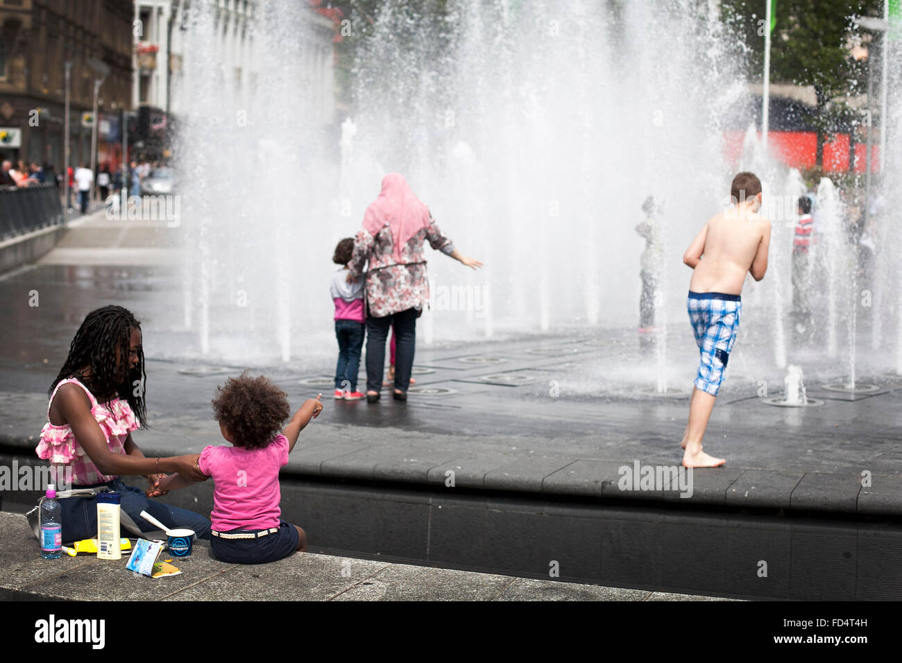 Water fountain at Piccadilly Gardens in Manchester on a sunny summer day Stock Photo