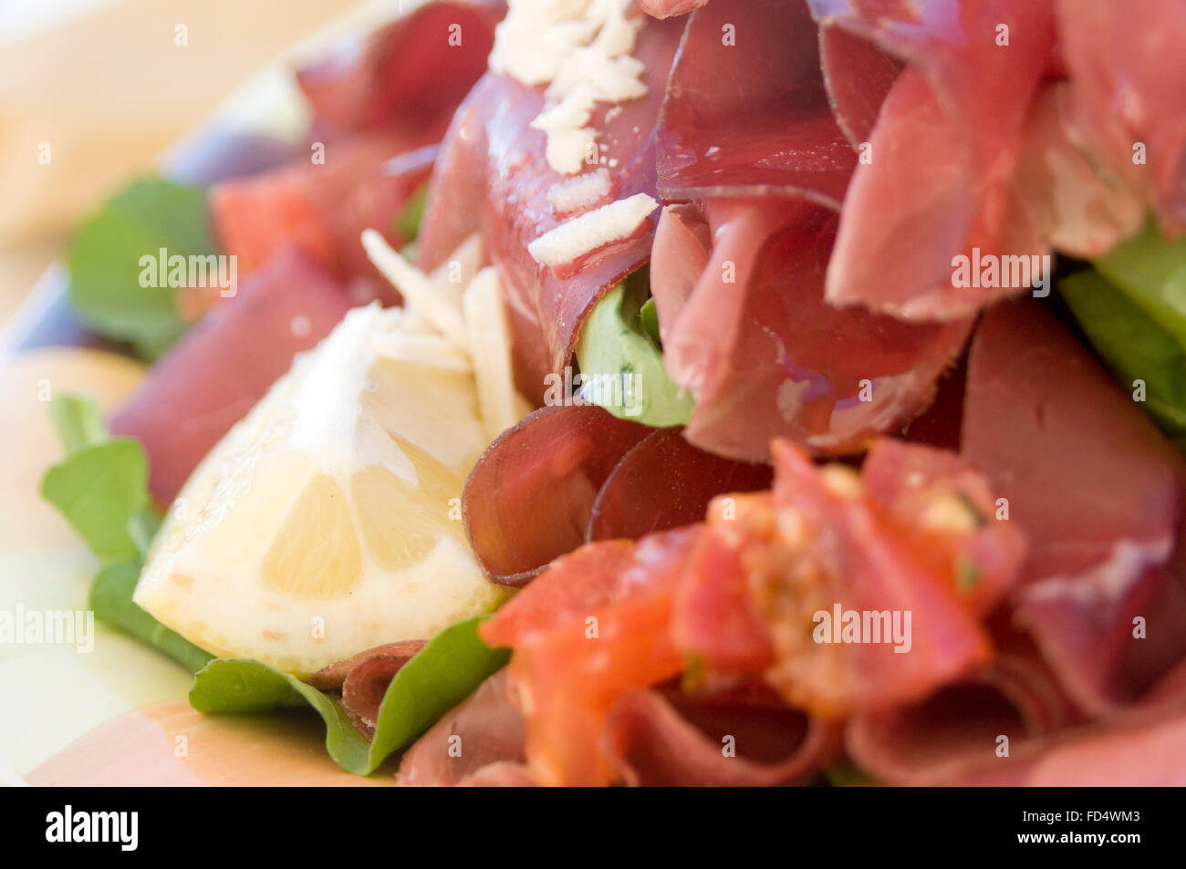 Bresaola brisaola  air dried salted beef cured curing meat beef red drying italy Italian delicacy salad salads rucola e grana ro Stock Photo