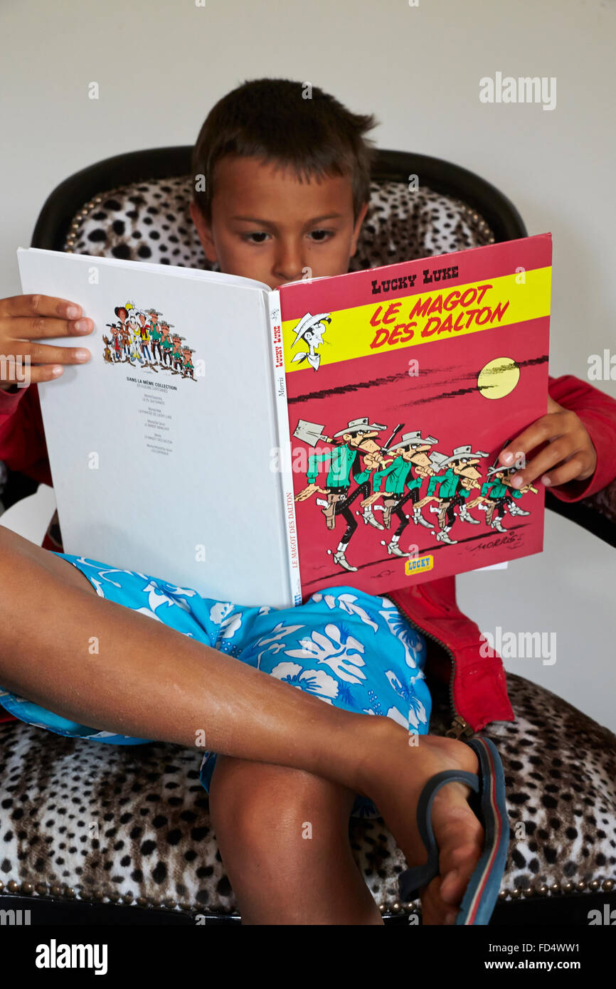 Boy reading comics. Stock Photo