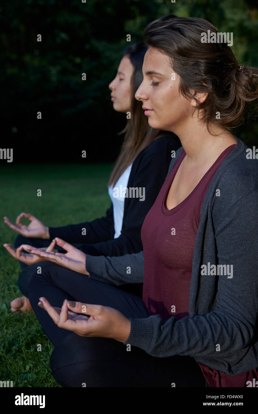 Teenagers practising meditation. Stock Photo