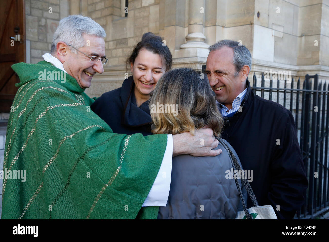 Catholic priest greeting parishioners after Mass Stock Photo