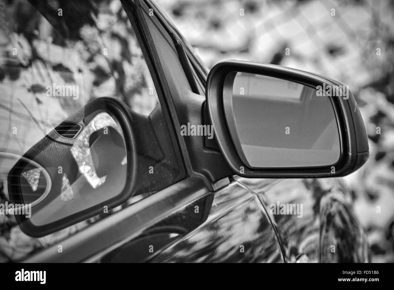 Closeup of a car rear-view mirror in black and white colors Stock Photo