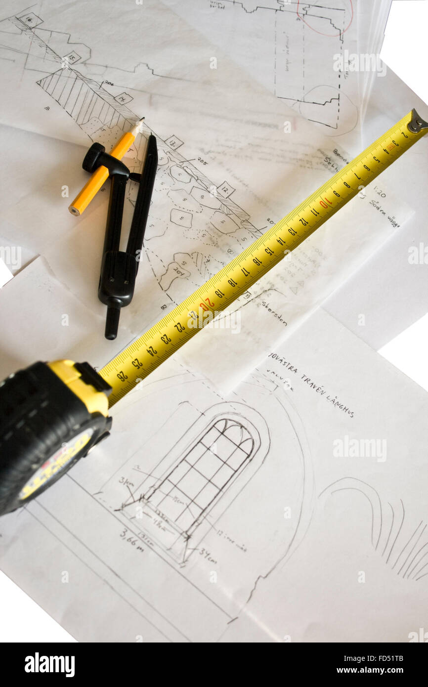 Measuring tape and compasses lying on drawings of building interiors. Stock Photo