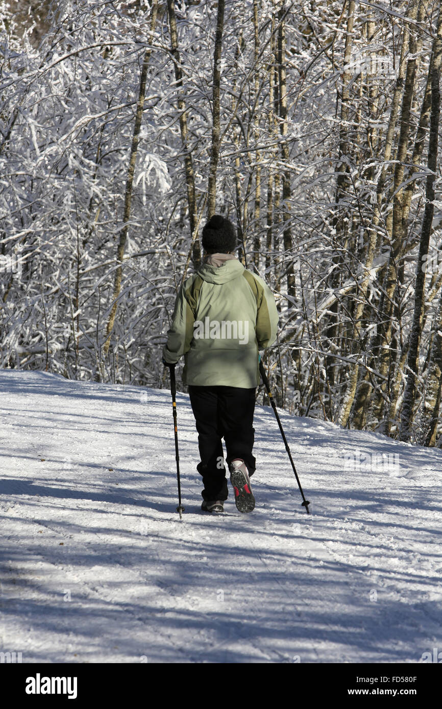 Woman walking on snow hi-res stock photography and images - Alamy