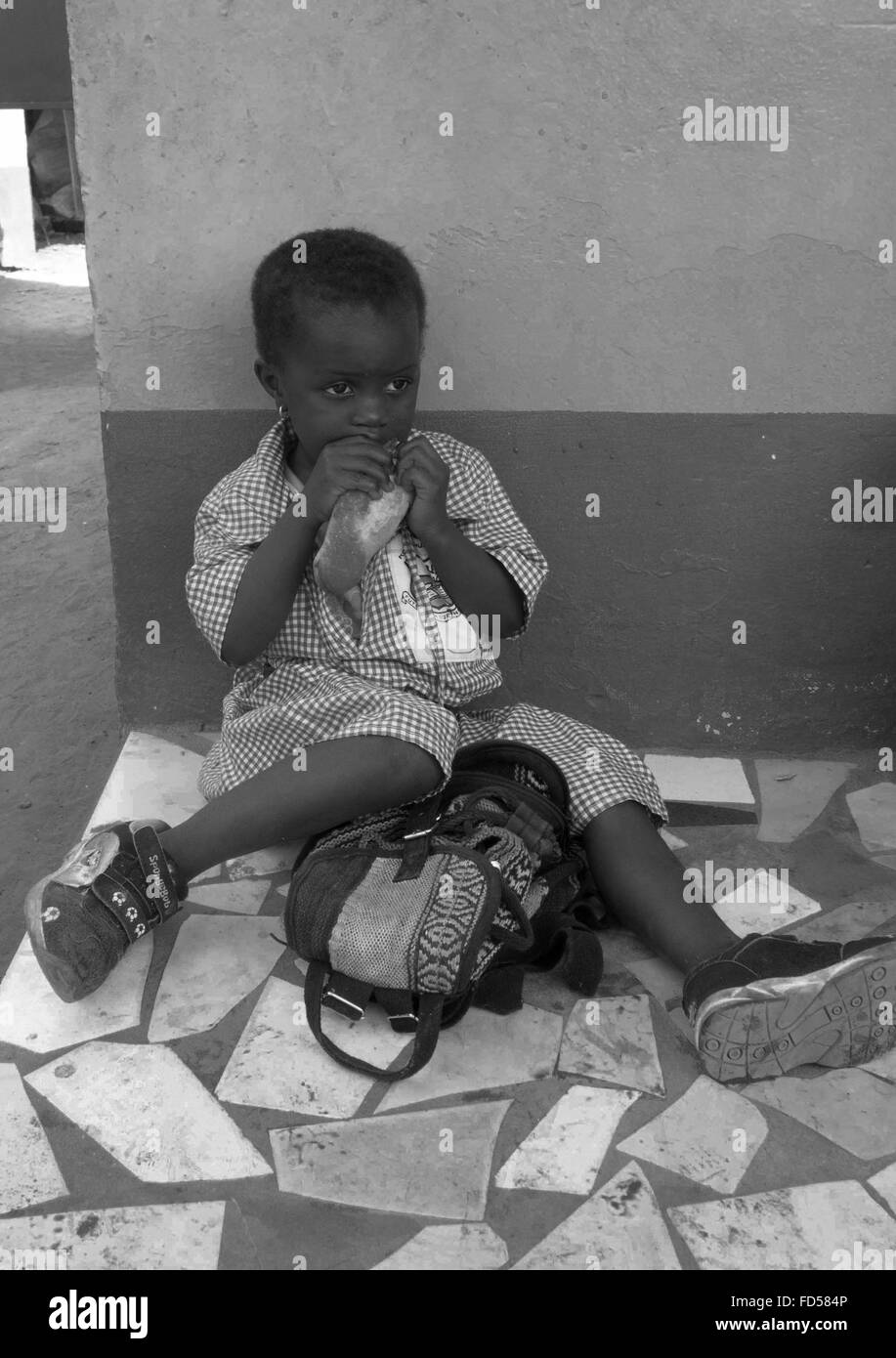 Lunch break for black infant child at a charity run school in the back streets of Kololi Gambia Stock Photo