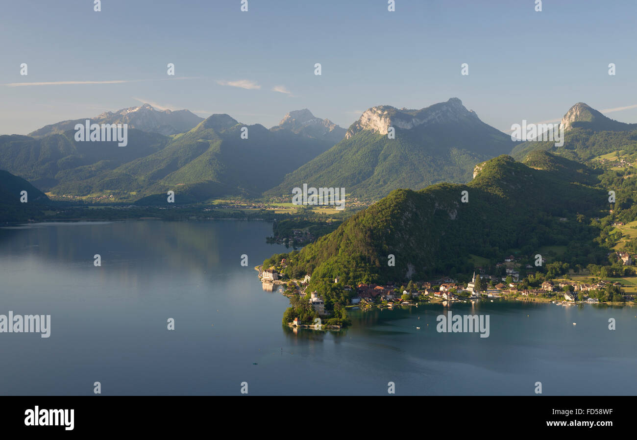 Forested ridge and rocks of Taillefer and Entrevernes mountains at Lake ...