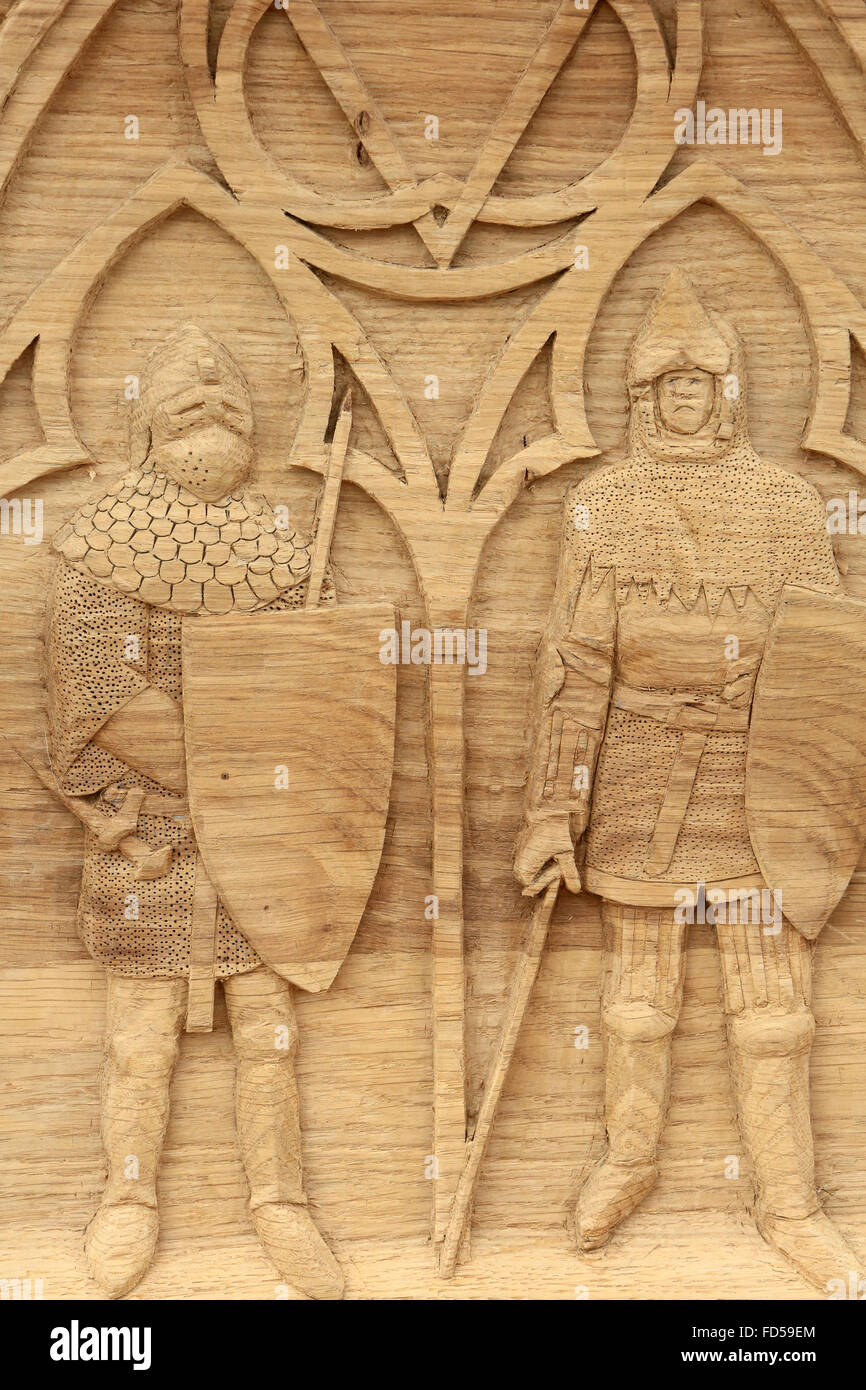 Medieval soldiers. Wood carving. Stock Photo