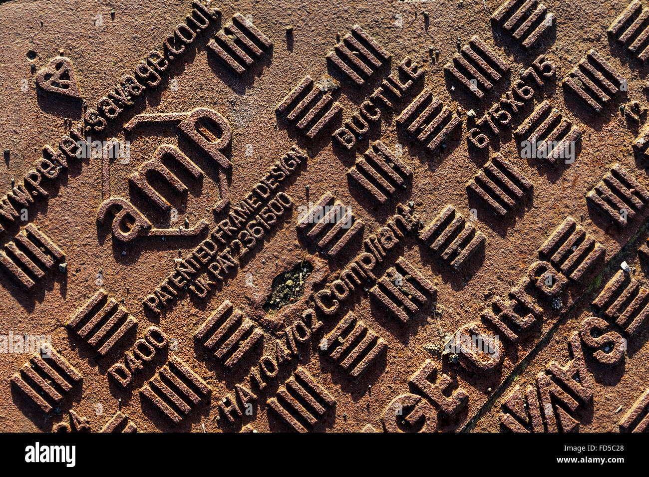 Abstract patterns of a rusty man hole cover Stock Photo