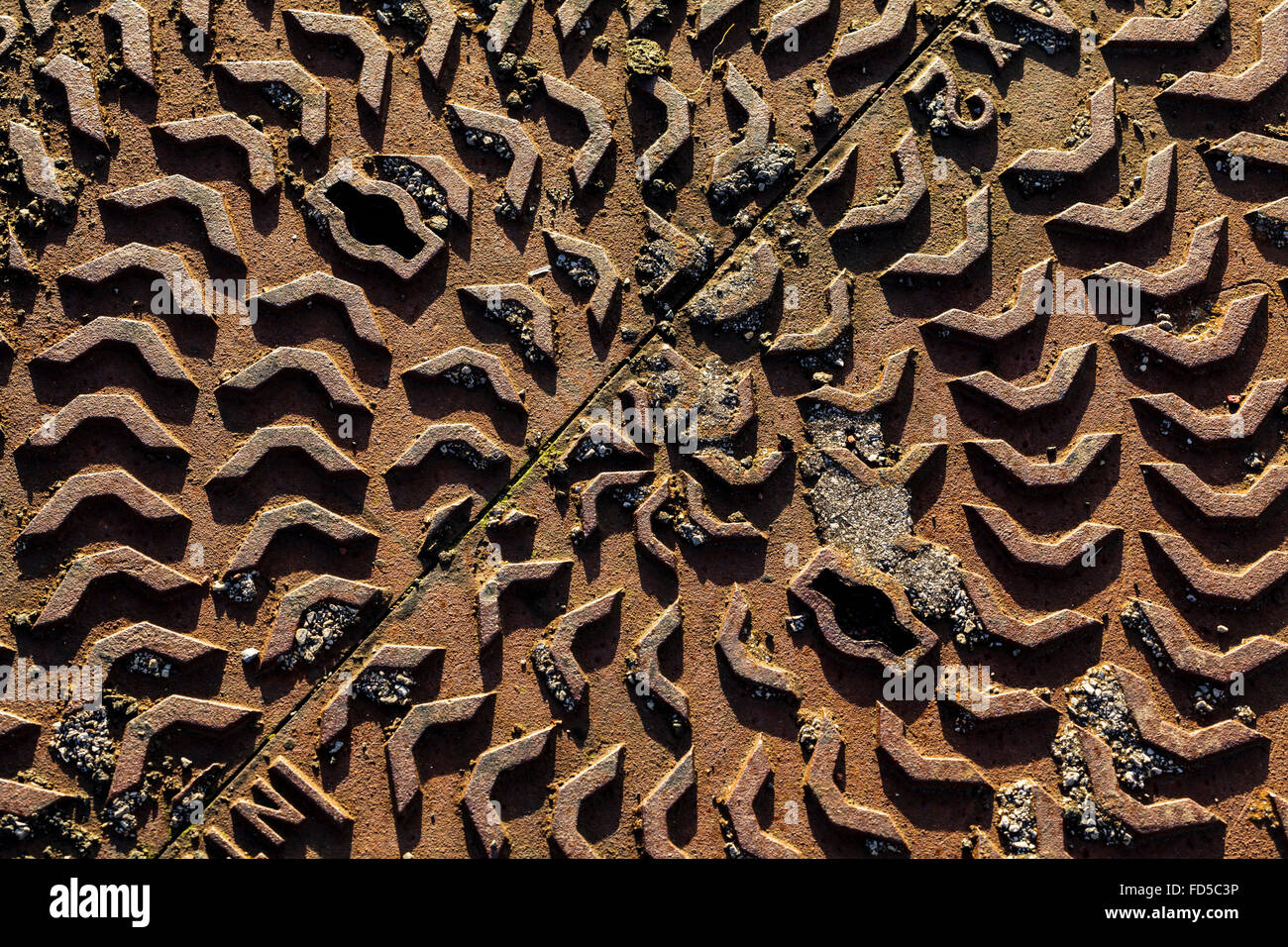 Circular patterns of a man hole cover Stock Photo