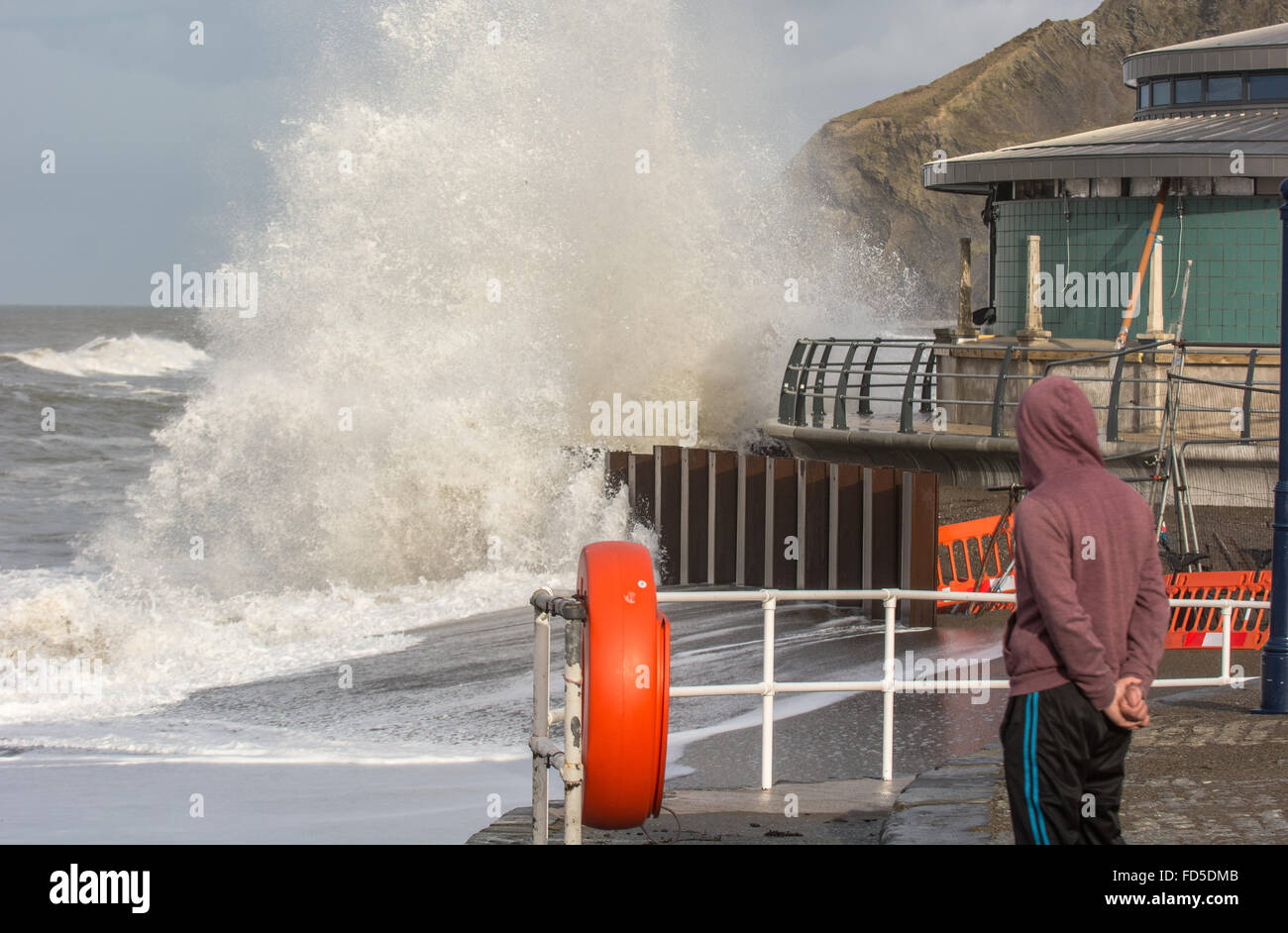 Aberystwyth, Ceredigion, West Wales, UK. 28th January, 2016. UK Weather: whilst the gale force winds from Storm Jonas have died down the sea is still pounding the coastline and with the sun breaking people have come out to watch and photograph the rough seas. Credit:  Trebuchet Photography / Alamy Live News Stock Photo