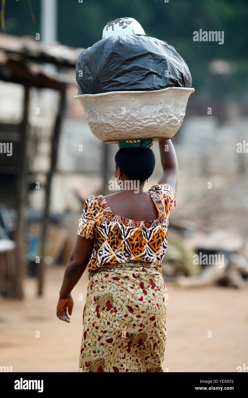 African woman. Carrying a large bowl on her head. Stock Photo