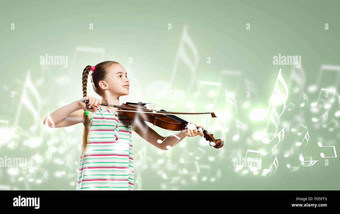 Image of cute girl playing violin against green background Stock Photo ...