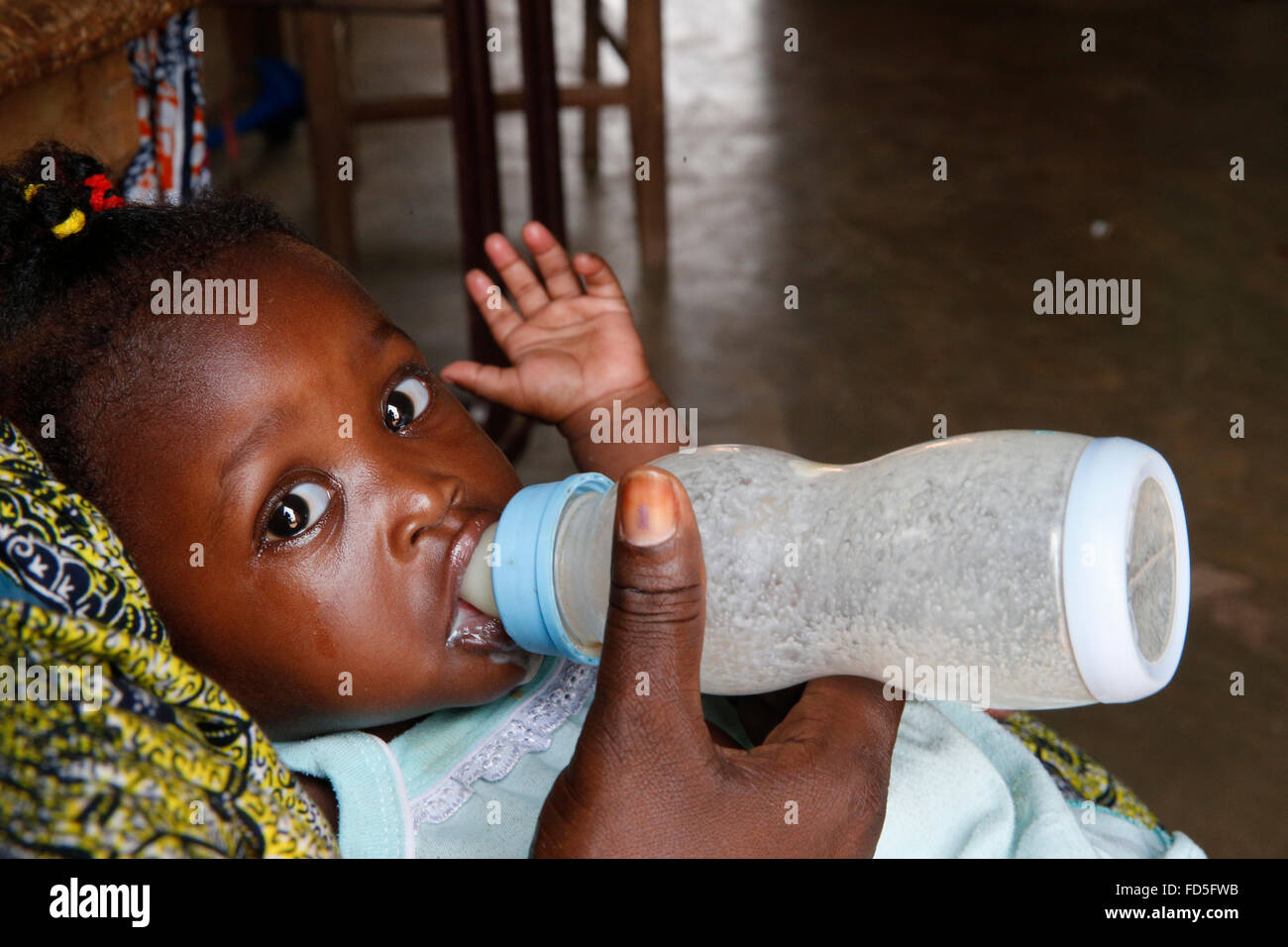 African baby drinking milk from a baby bottle Stock Photo Alamy