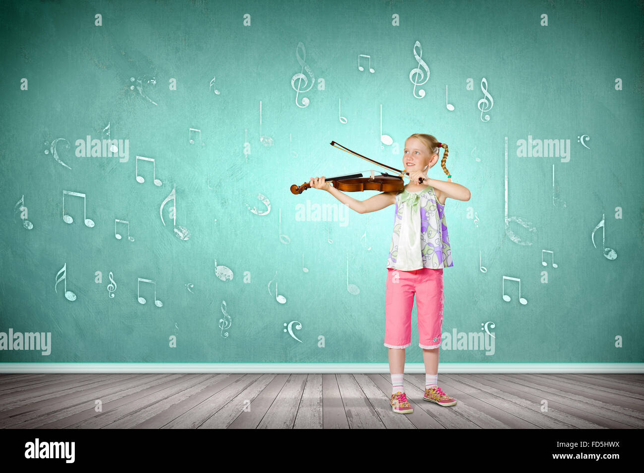 Image of cute girl playing violin against green background Stock Photo ...