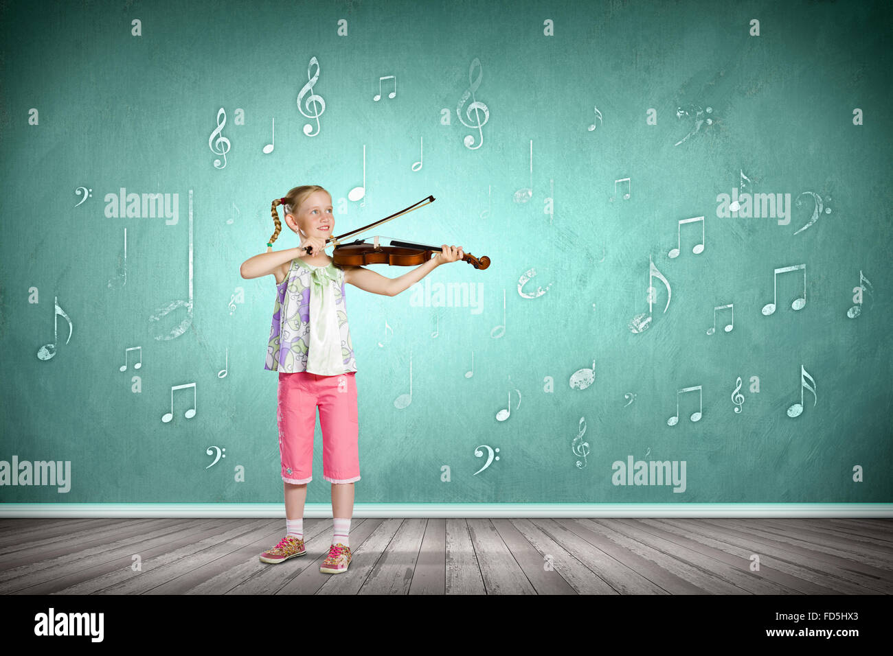 Image of cute girl playing violin against green background Stock Photo ...