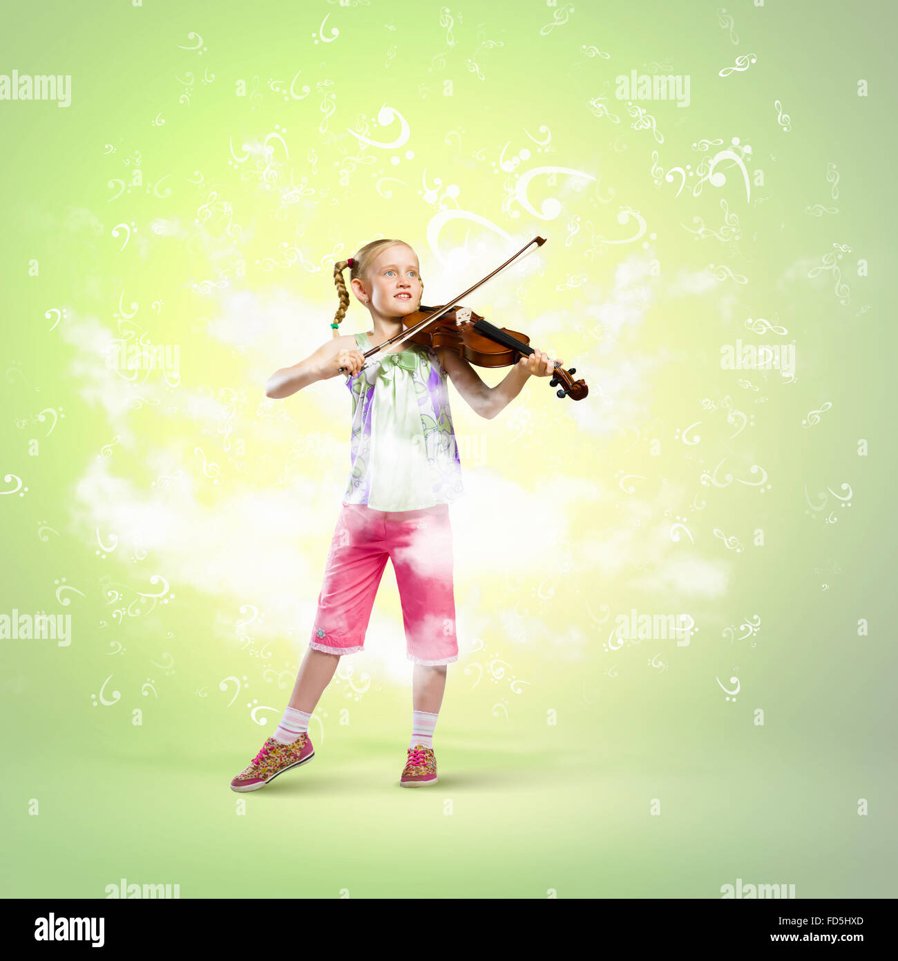 Image of cute girl playing violin against green background Stock Photo ...