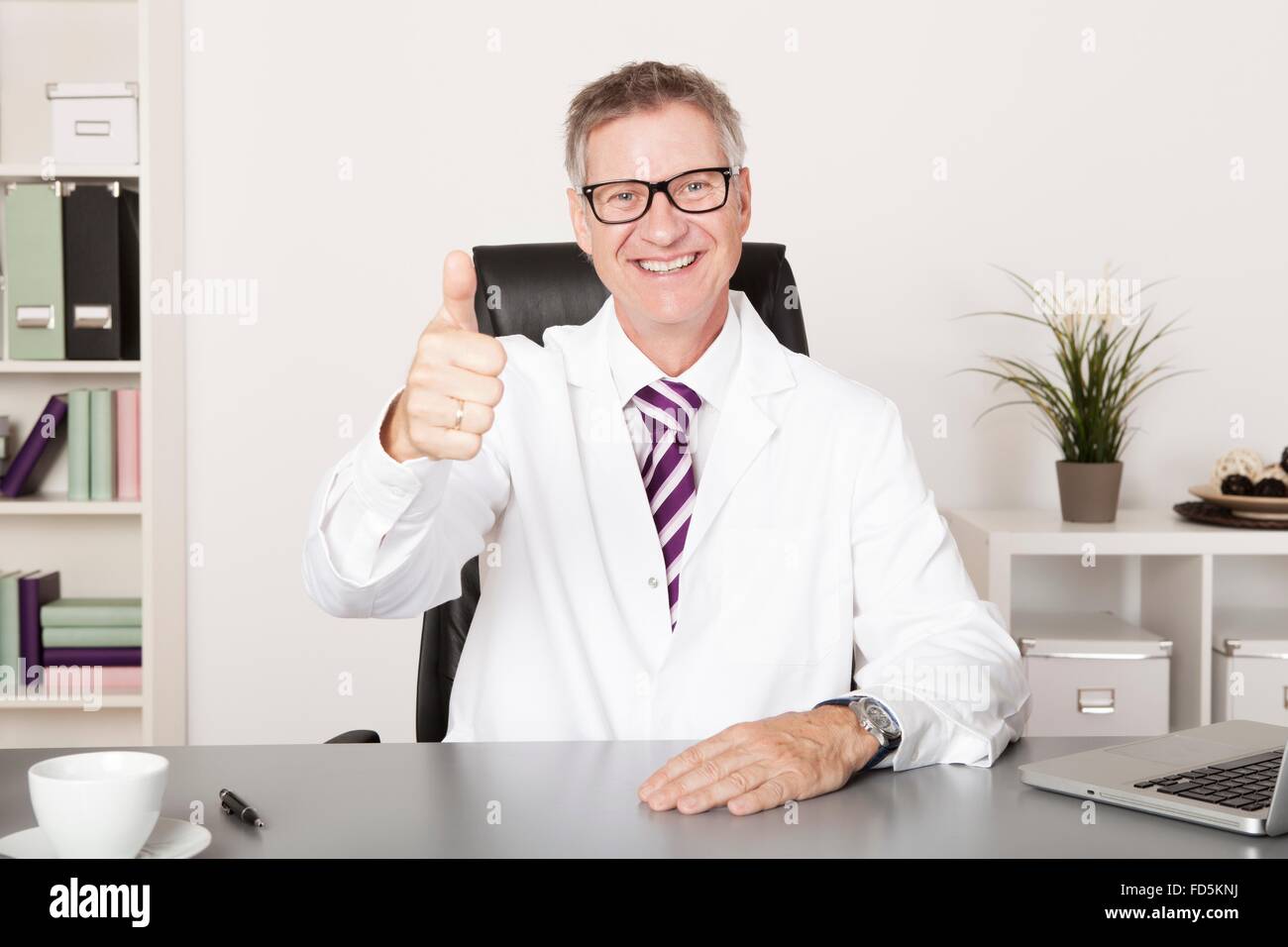 Happy Medical Doctor Showing Thumbs up at Hand Emphasizing Well Job Done Stock Photo