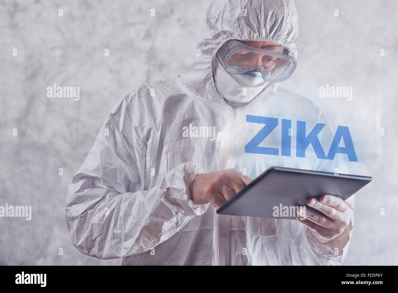 Zika virus concept, medical worker in protective clothes using digital tablet computer to access internet Stock Photo