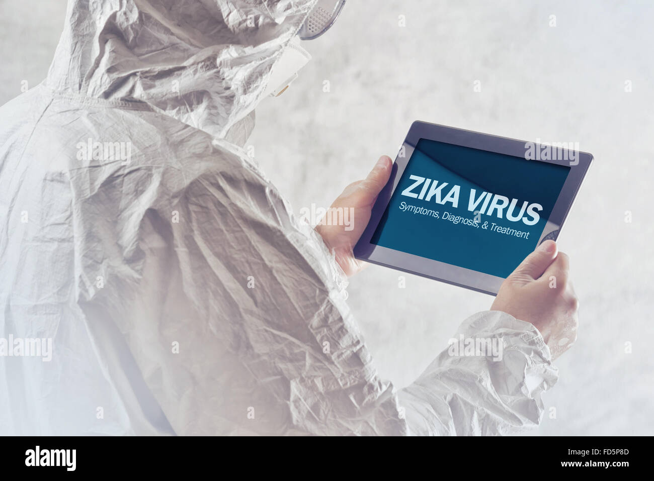 Zika virus concept, medical worker in protective clothes using digital tablet computer to access internet Stock Photo