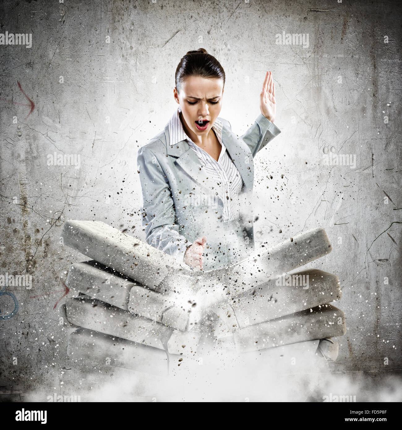 Image of businesswoman breaking bricks with hand Stock Photo - Alamy