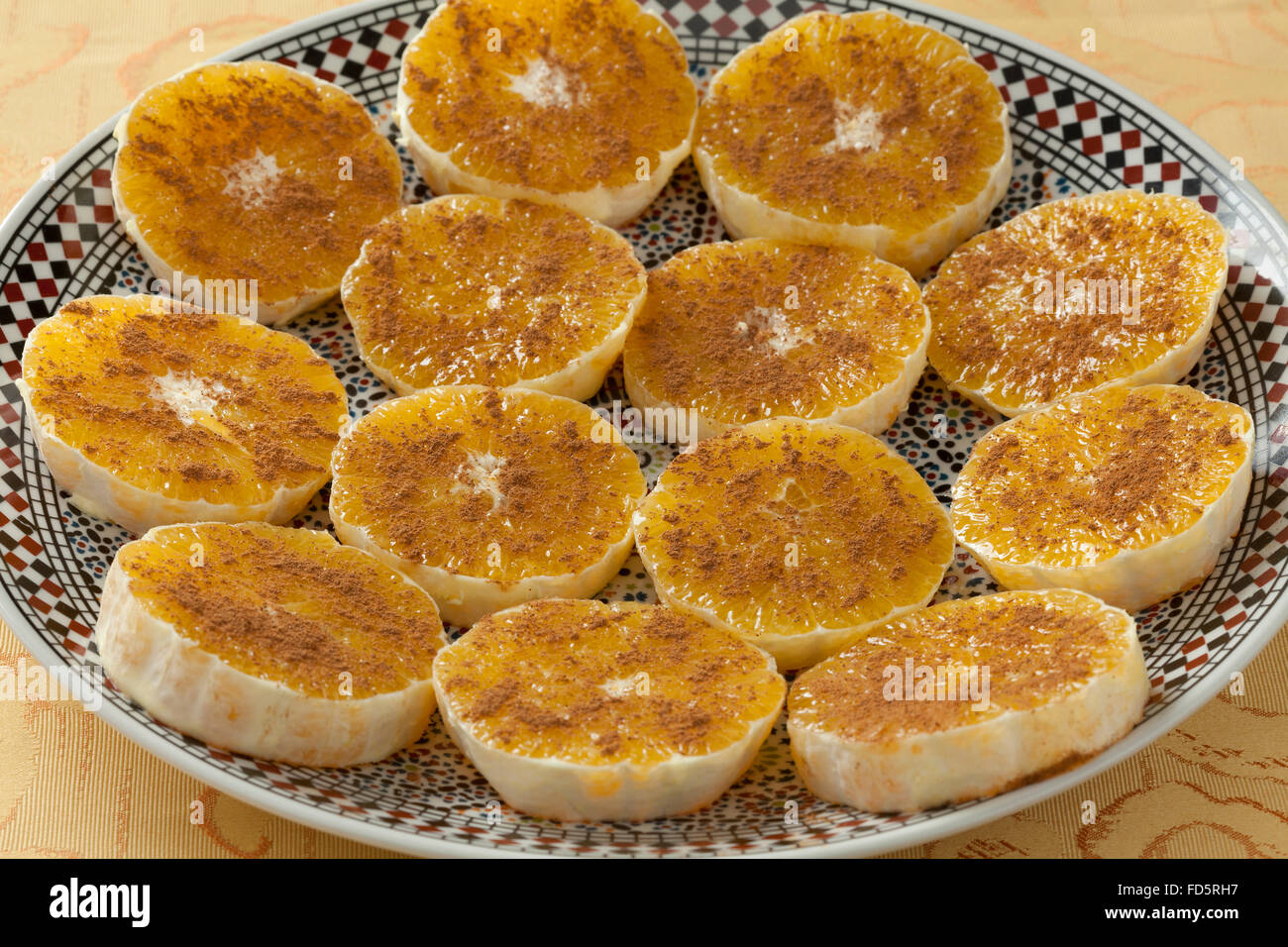 Traditional Moroccan orange slices with sugar and cinnamon as dessert Stock Photo