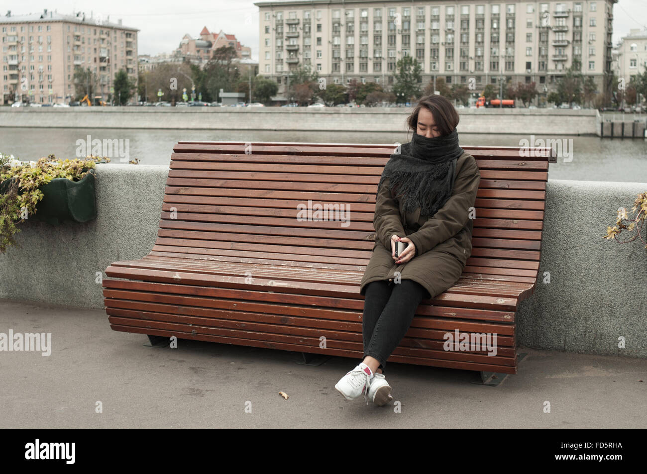 Sad girl sitting on bench hi-res stock photography and images - Alamy