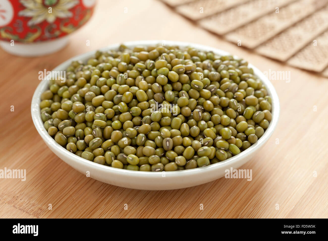 Bowl with dried Mung beans on the table Stock Photo