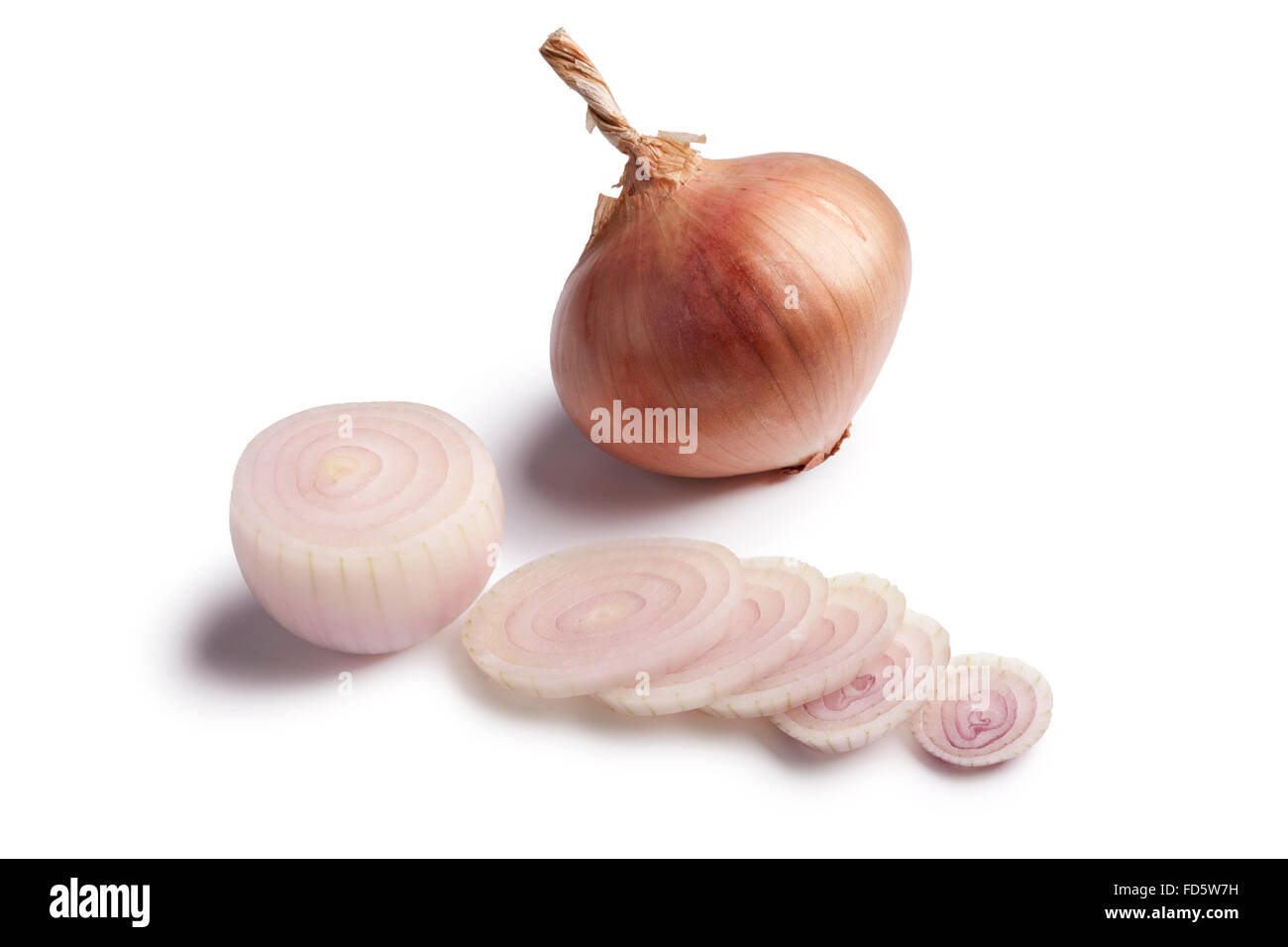 Fresh pink Roscoff onions and slices on white background Stock Photo