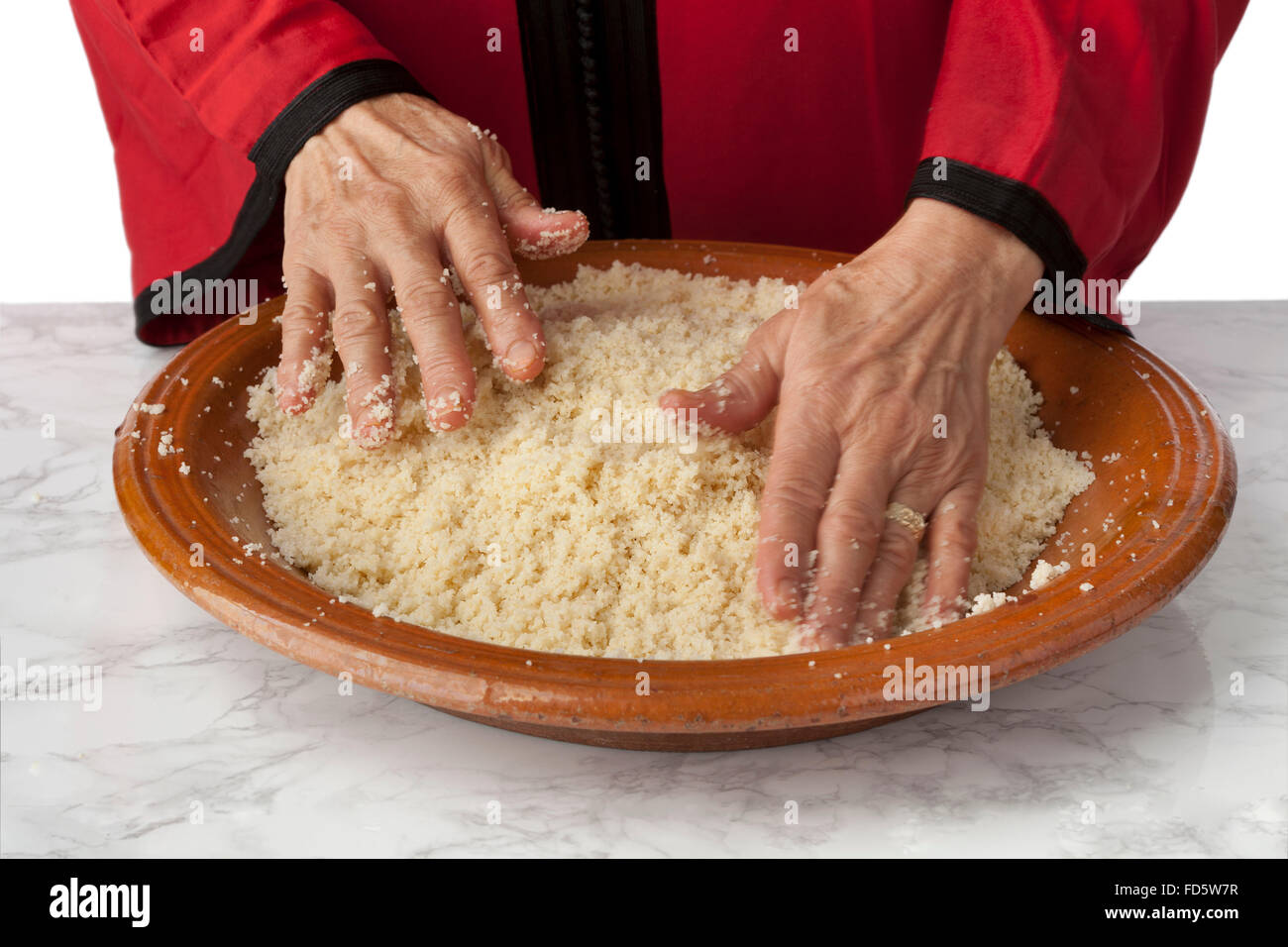 Women's hands making traditional Moroccan couscous Stock Photo