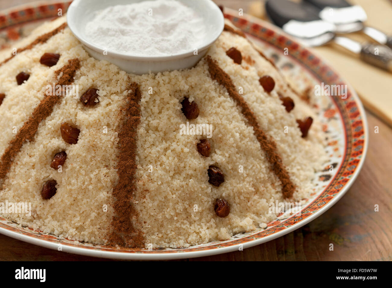 Traditional Moroccan sweet couscous with cinnamon, raisons and sugar Stock Photo