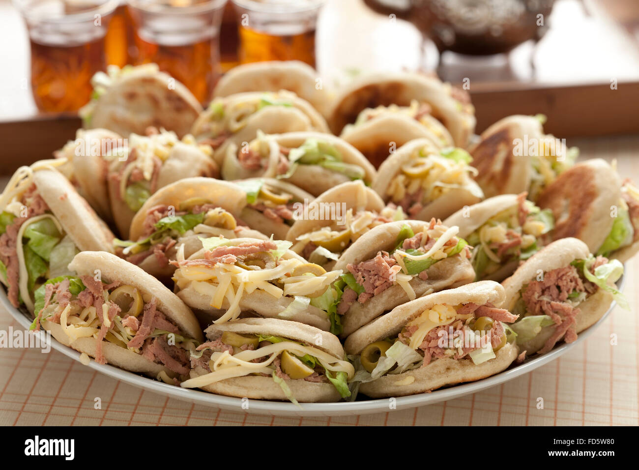 Fresh traditional Moroccan batbot sandwiches filled with saucage,lettuce,cheese and tuna on a dish Stock Photo