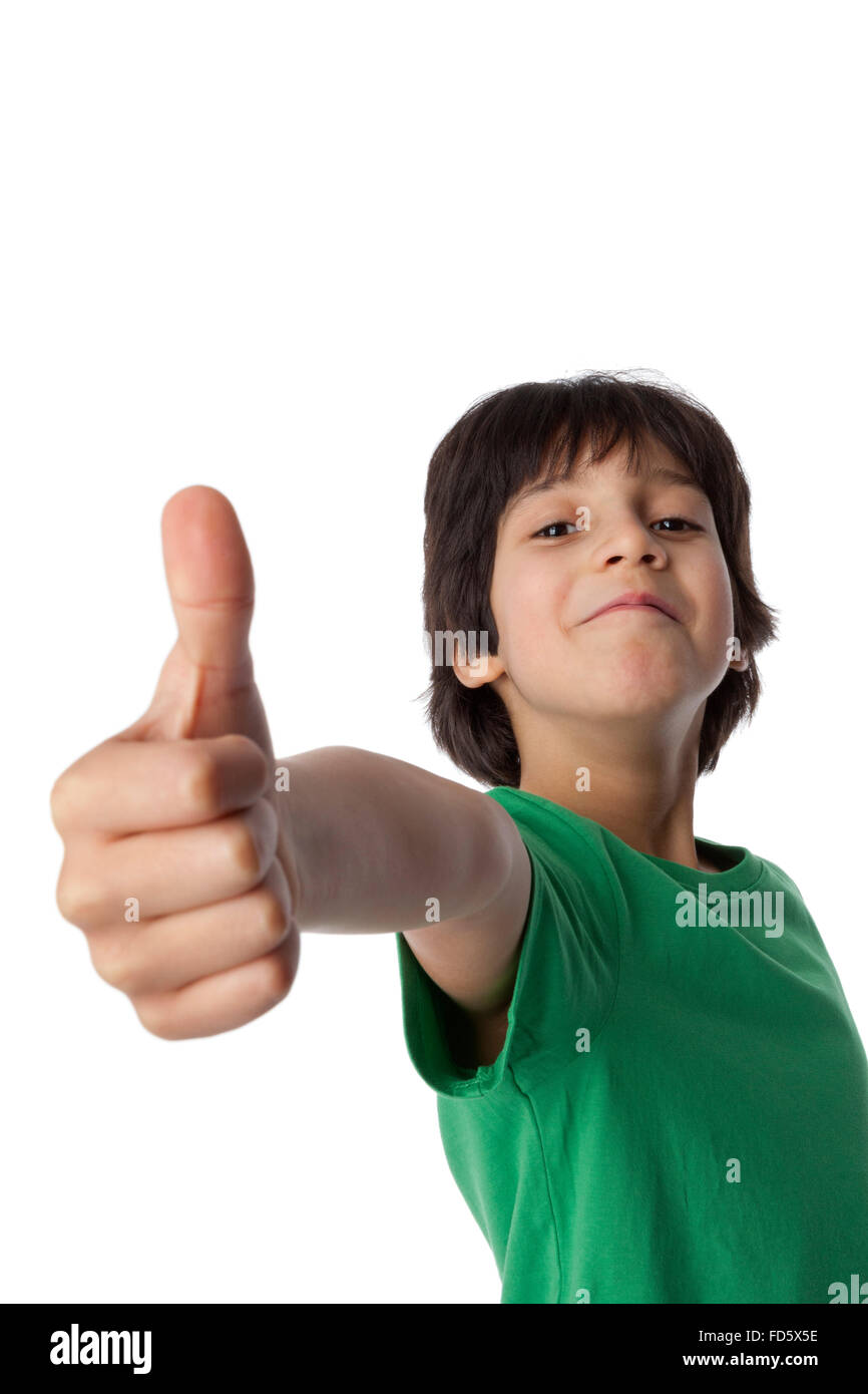 Happy eight year old boy sticks his thumb up on white background Stock Photo