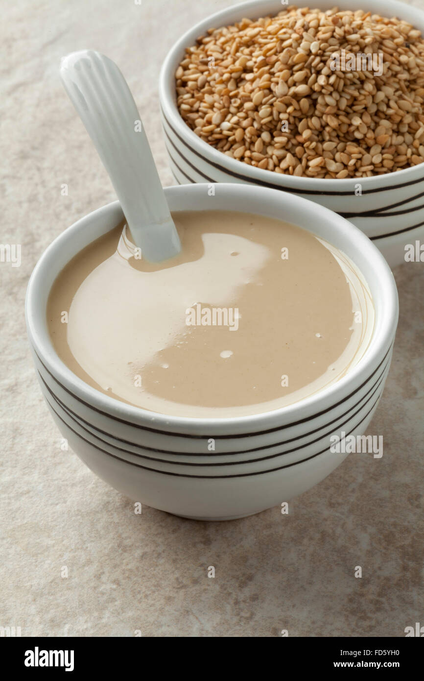 Bowls with tahini paste and roasted sesame seeds Stock Photo