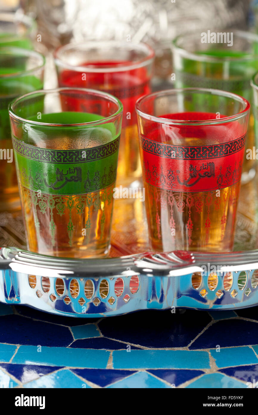 Moroccan tea glasses  in the colors of the Moroccan flag with in Arabic letters written tea Stock Photo