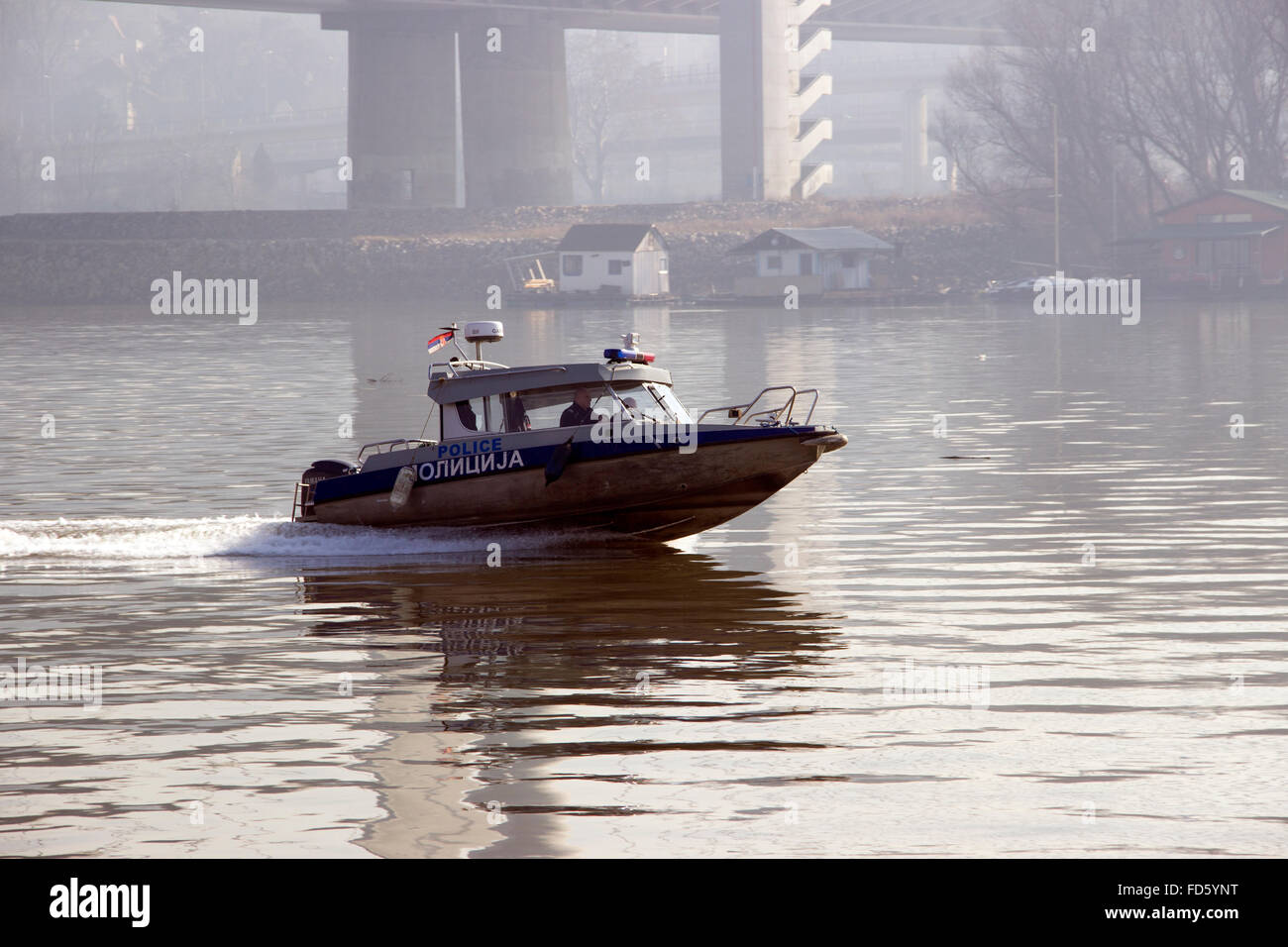 Belgrade, Serbia - Police speed boat patrolling along the Sava river at a foggy winter morning Stock Photo