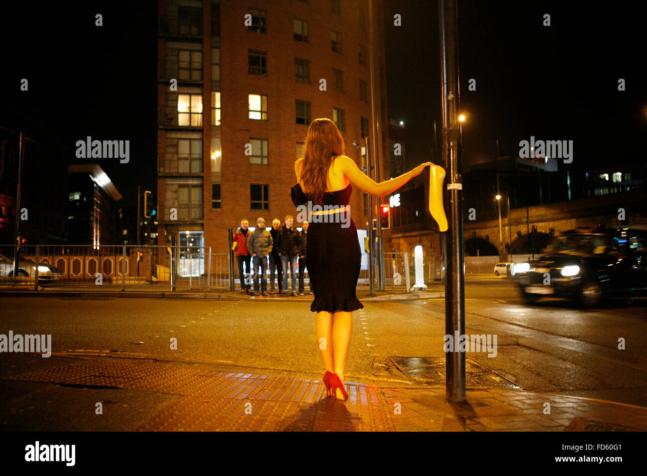 Deansgate lock  A young woman prepares to cross the road at 2am friday evening. Manchester. Stock Photo