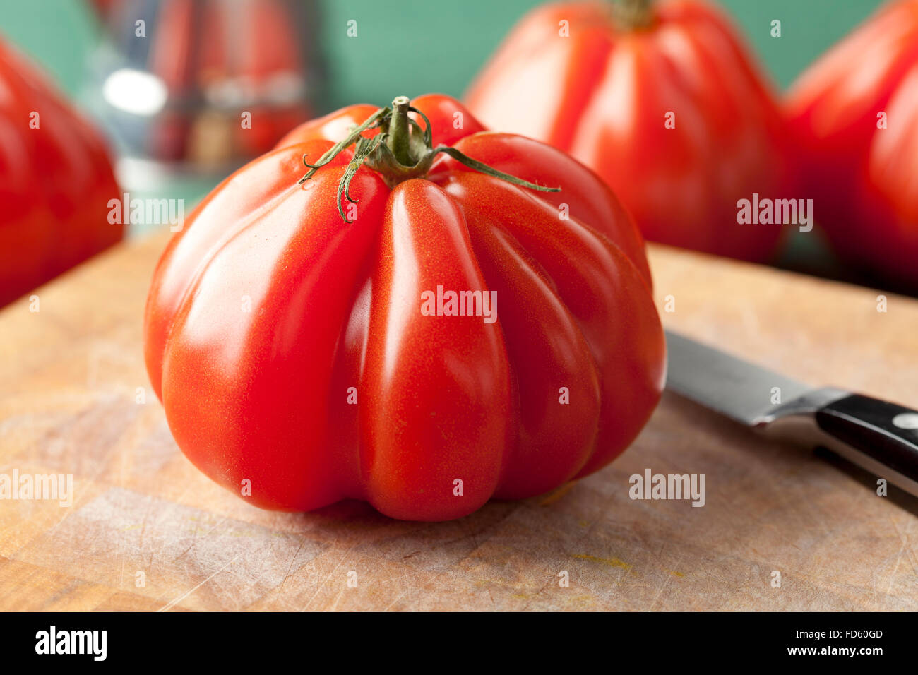 Whole fresh Coeur de Boeuf Tomato Stock Photo