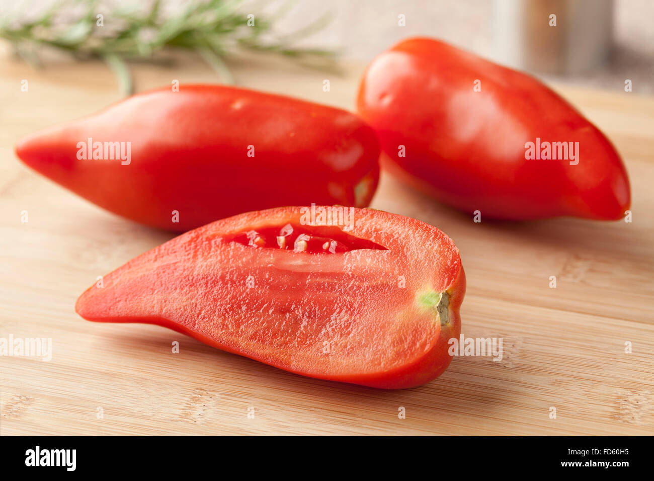Whole and half fresh Cornue des Andes tomatoes Stock Photo