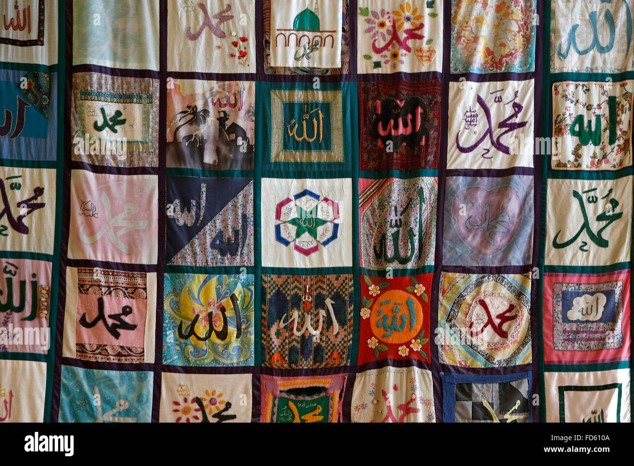 Patchwork tapestry in the mosque of the Sheikh Nazim sufi centre, London. Names of Allah and his prophet Muhammad. Stock Photo