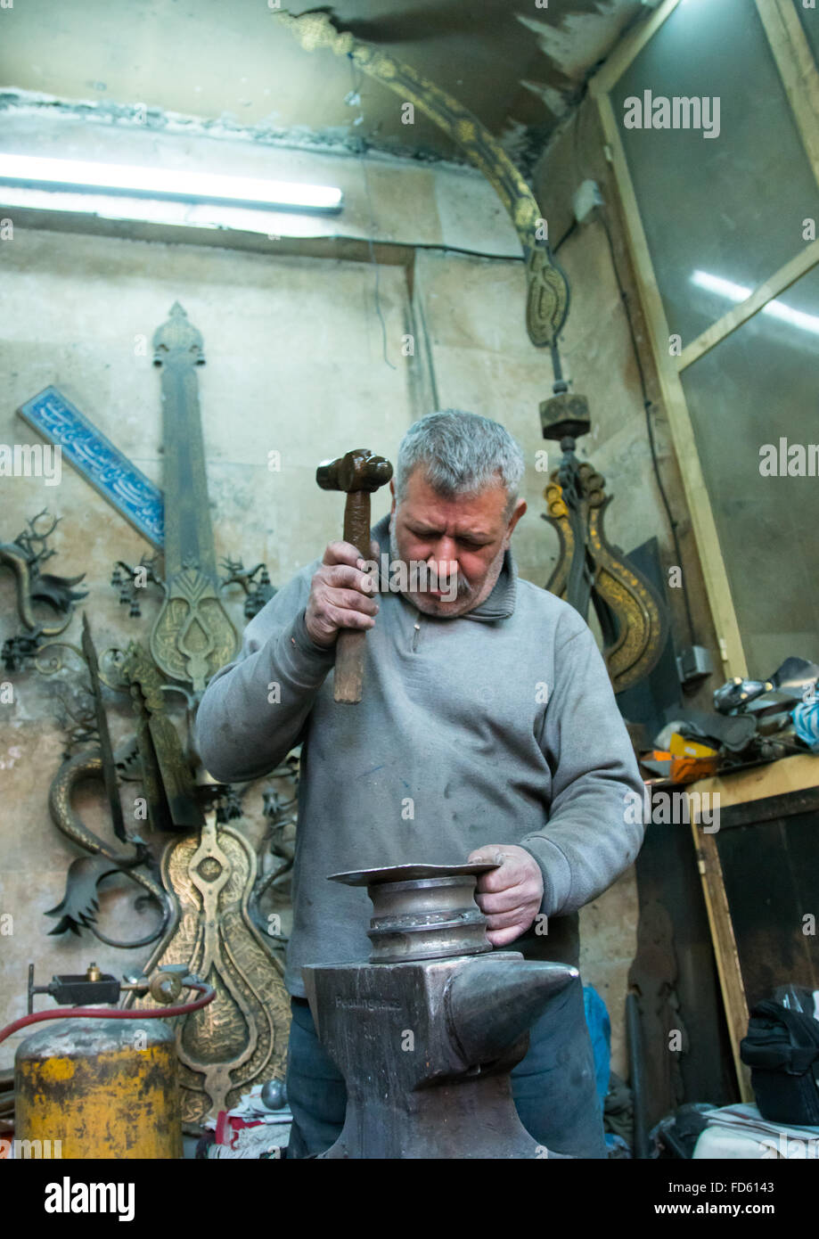 master safar fooladgar creating an alam in his workshop, Central district, Tehran, Iran Stock Photo