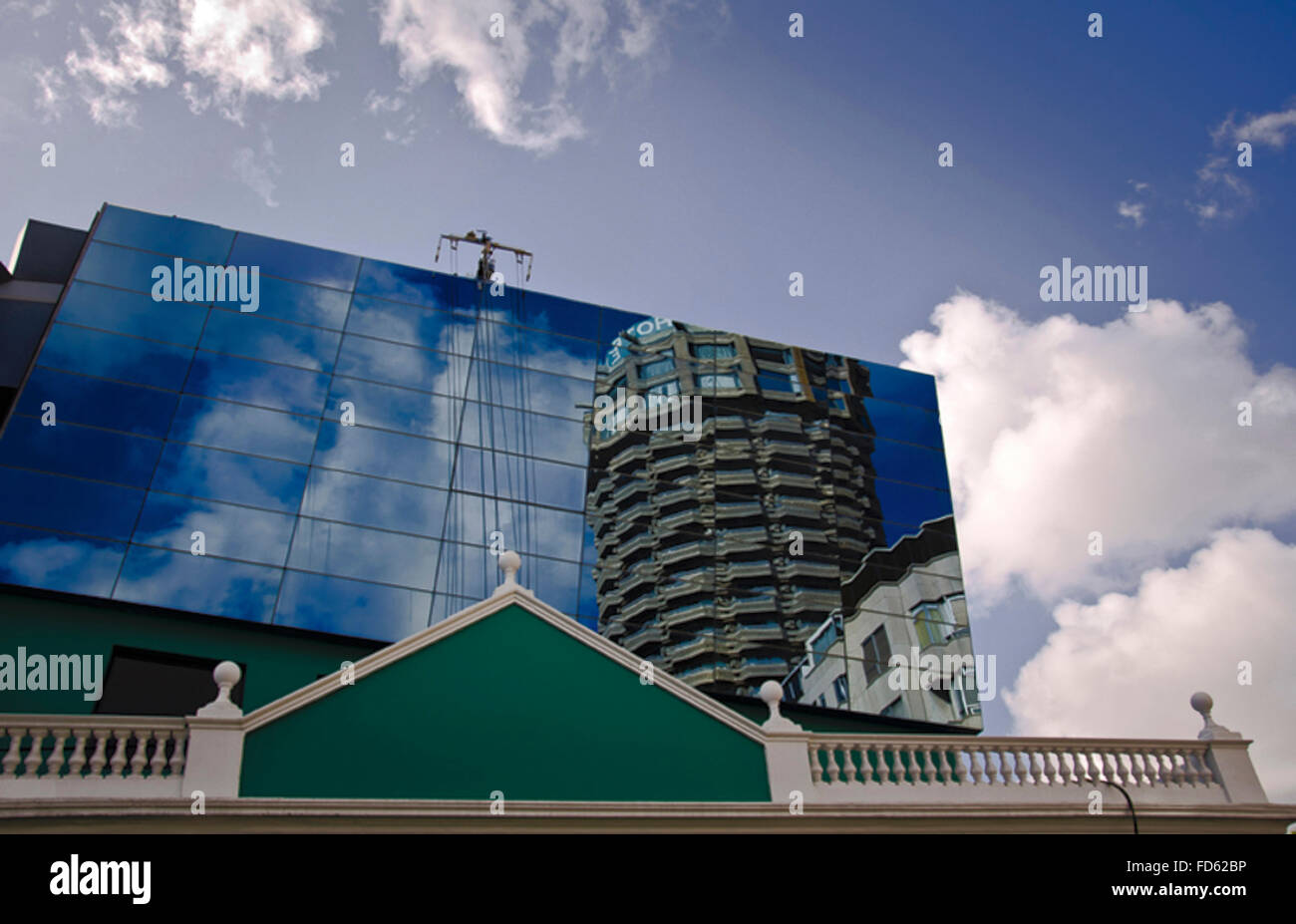 A contrast between the sky and a mirror with a building into Stock ...