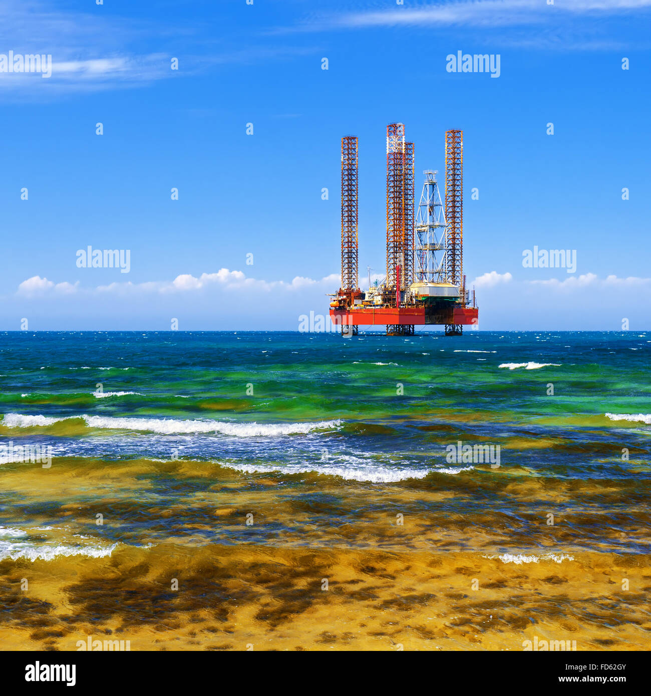 Offshore oil and Gas Production. Drilling platform in the sea against a blue sky Stock Photo