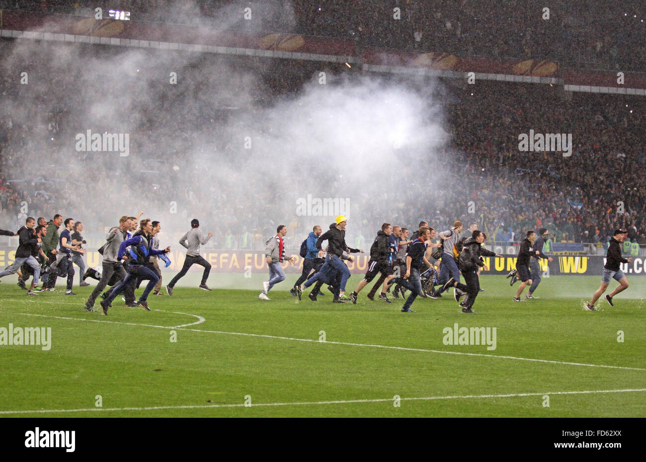 FC Dnipro supporters run out into the pitch to celebrate victory after UEFA Europa League semifinal game against Napoli Stock Photo