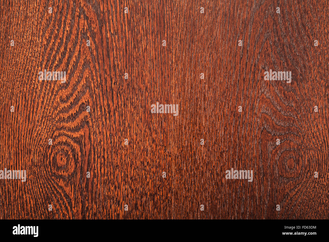 Background texture of dark red wooden veneer sheet with knots and natural pattern lines Stock Photo