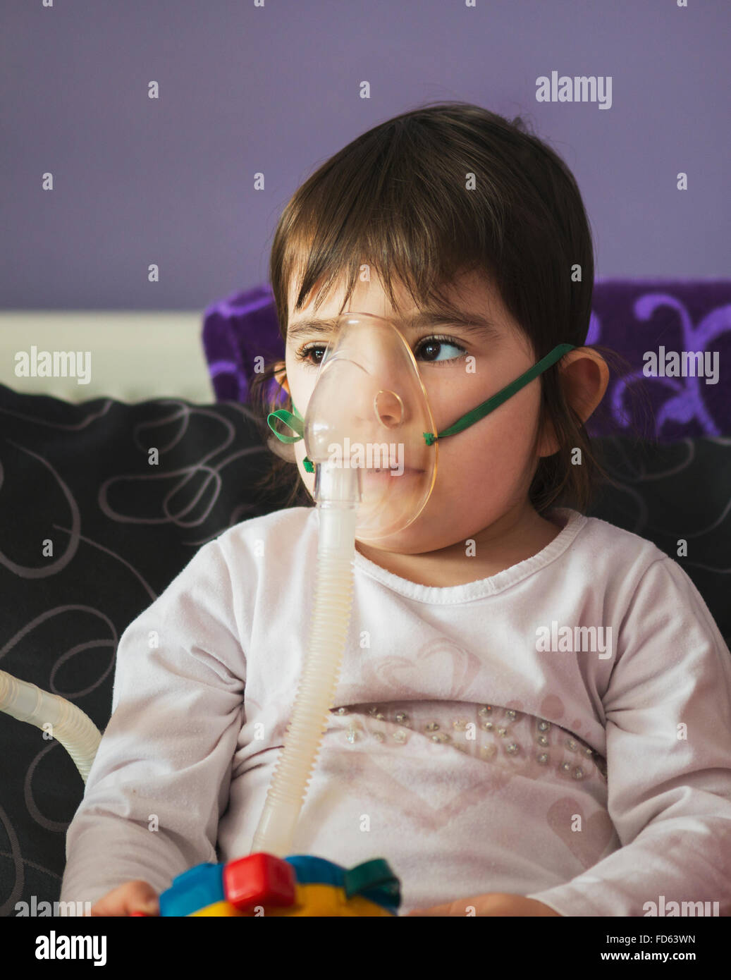 girl making inhalation with mask on her face Stock Photo