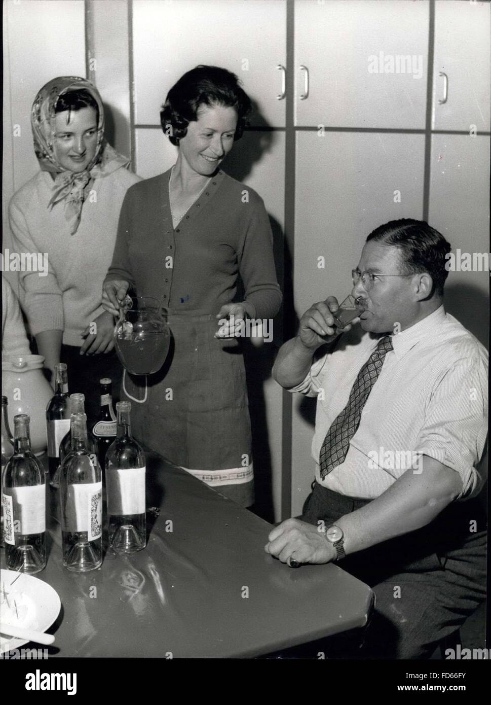1958 - The Taste Of Things To Come: Sir Bernard Waley-Cohen Decides The Liquid Refreshment Before A Junior Hunt Ball To Be Held At His Home On Exmoor: Sir Bernard is a man of a many parts and accomplishments. At his home, he is ''off-duty'' and insists on seeing domestic arrangements for a social function are properly handled - even to getting down to wine testing, using his experience and knowledge on behalf of the Ball Committee. Watching her father on the left is Joanna. Wearing a headscarf is Miss Elizabeth Matson, daughter of the Joint Master of Sir Watkin William Wyn's Hunt, and next to  Stock Photo