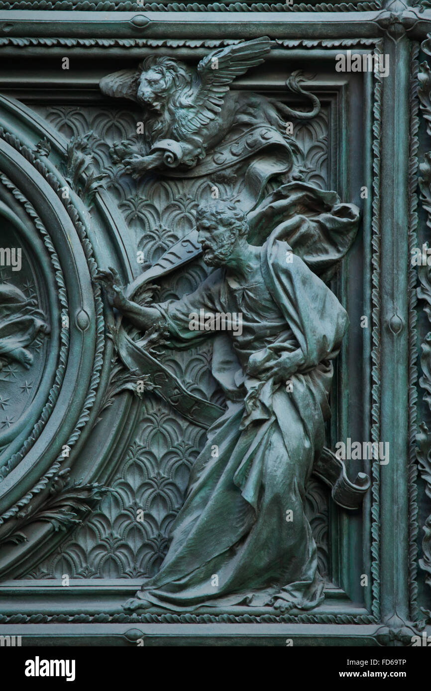 Saint Mark the Evangelist. Detail of the main bronze door of the Milan Cathedral (Duomo di Milano) in Milan, Italy. The bronze door was designed by Italian sculptor Ludovico Pogliaghi in 1894-1908. Stock Photo