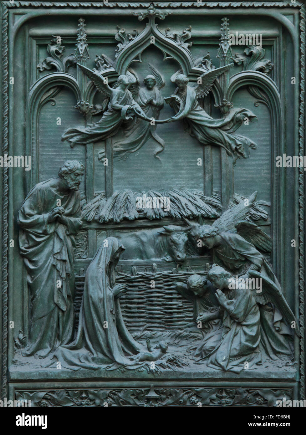 Nativity of Jesus. Detail of the main bronze door of the Milan Cathedral (Duomo di Milano) in Milan, Italy. The bronze door was designed by Italian sculptor Ludovico Pogliaghi in 1894-1908. Stock Photo