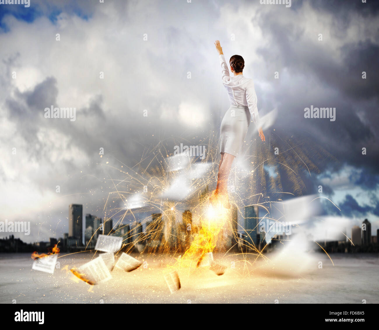 Image of businesswoman flying up into sky Stock Photo - Alamy